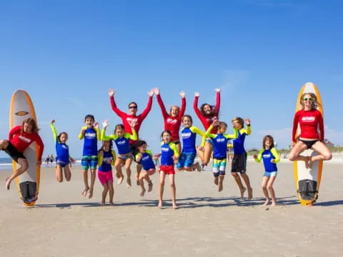 a group of kids posing for a photo on a beach