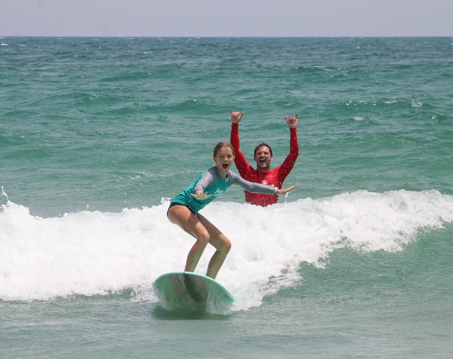 a man and a woman surfing