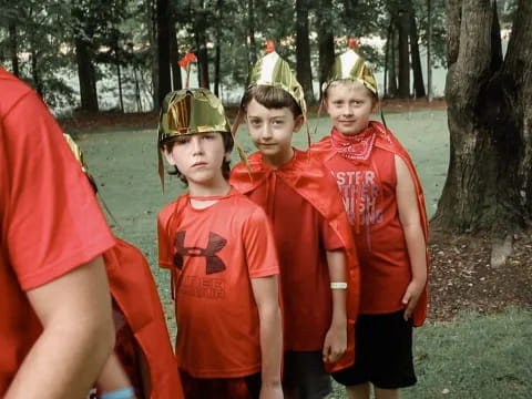 a group of boys in red uniforms