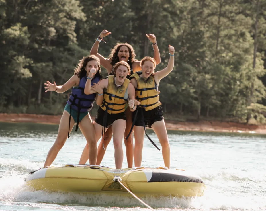 a group of women on a paddle board