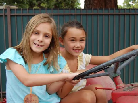 a couple of girls sitting on a bench