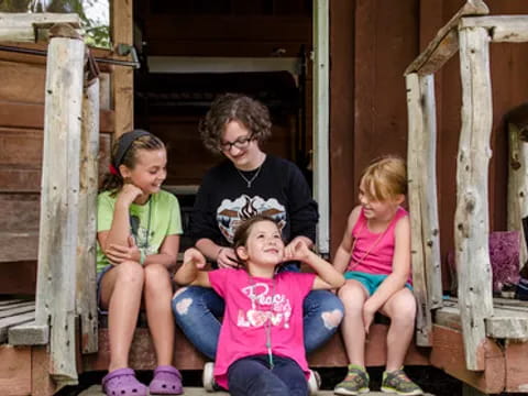 a group of people sitting on a porch