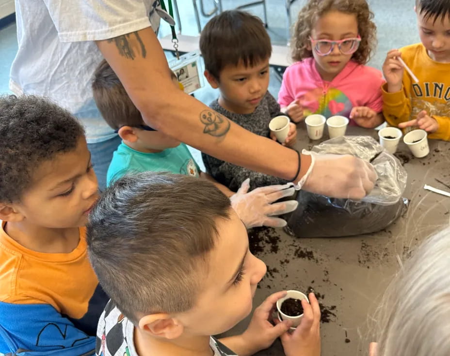 a group of children sitting around a table