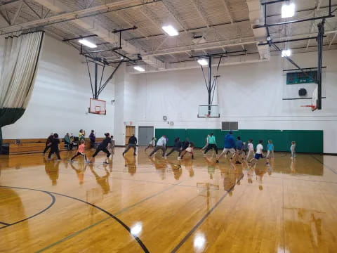 a group of people playing basketball