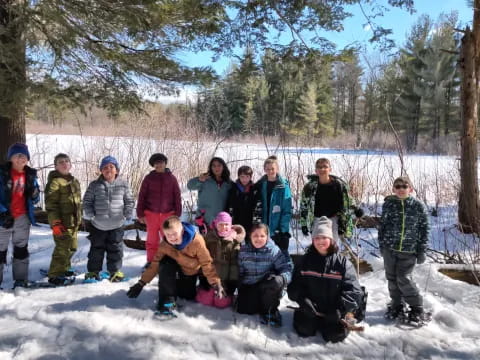 a group of people posing for a photo in the snow