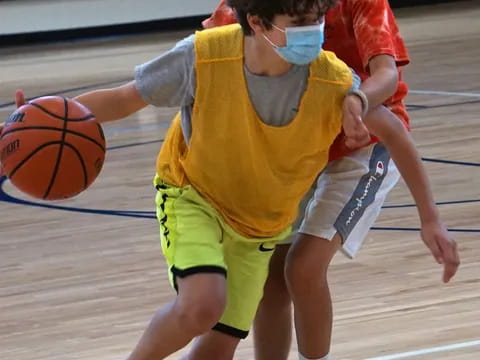 a group of boys playing basketball