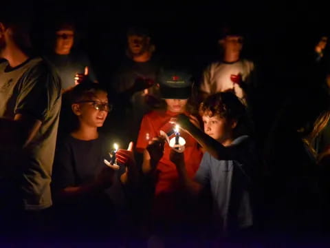 a group of people holding candles