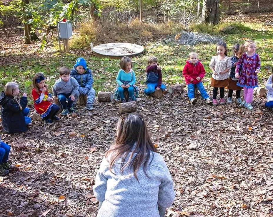 a group of children sitting on the ground