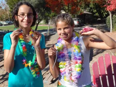 a couple of girls holding flowers