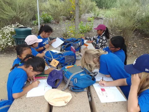 a group of people sitting outside