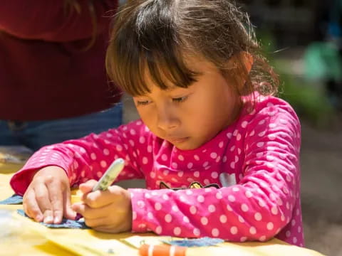 a young girl coloring on a paper