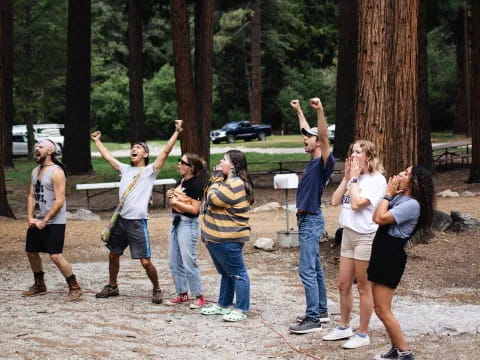 a group of people holding up a tree