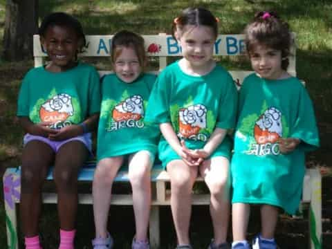 a group of children sitting on a bench