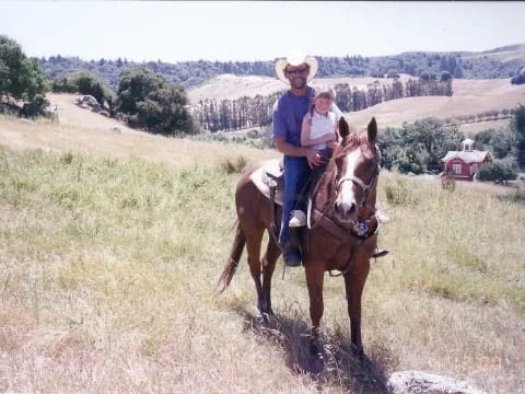 a man and a woman riding horses