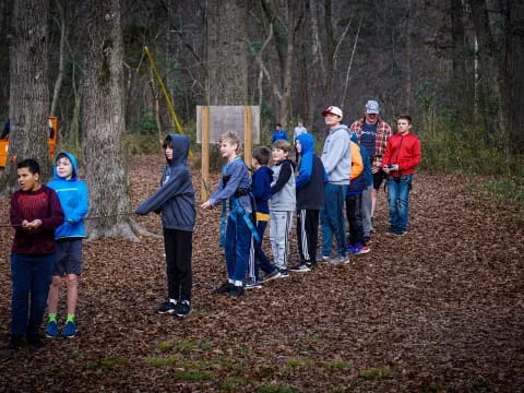 a group of people standing in a forest