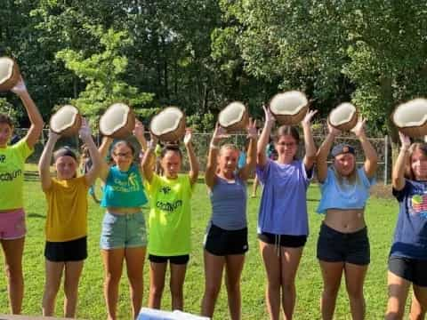 a group of girls holding white objects