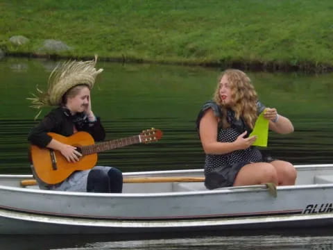 a couple of people in a boat playing instruments