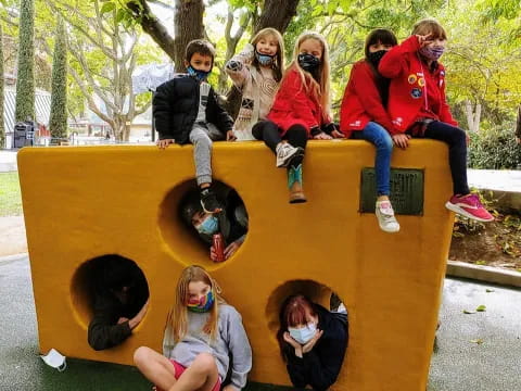 a group of people sitting on a yellow slide