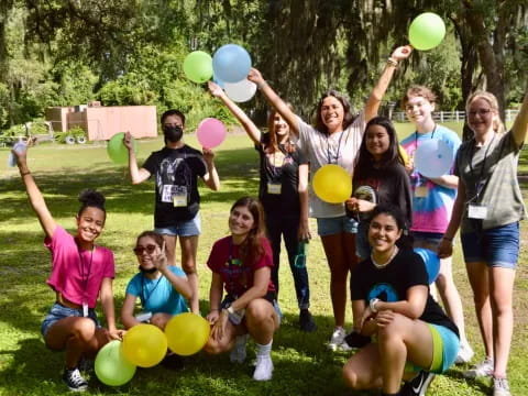 a group of people holding balloons