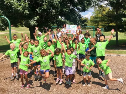 a group of children in green shirts