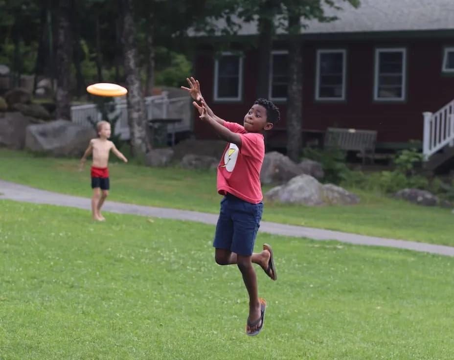 a person jumping to catch a frisbee
