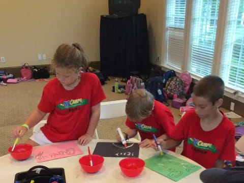 a group of children painting