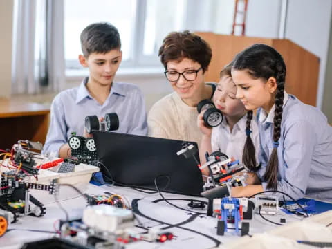 a group of people working on a laptop