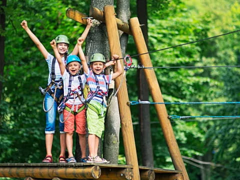 a group of kids on a swing