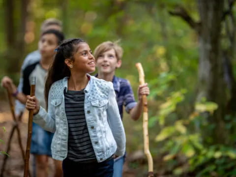 a group of people walking through the woods