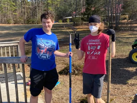 a couple of boys holding sticks