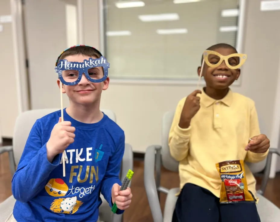 a couple of boys wearing masks and holding tooth brushes