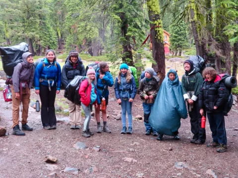 a group of people standing in the woods