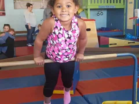 a girl standing on a blue mat