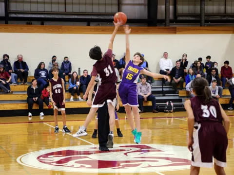 a group of people playing basketball