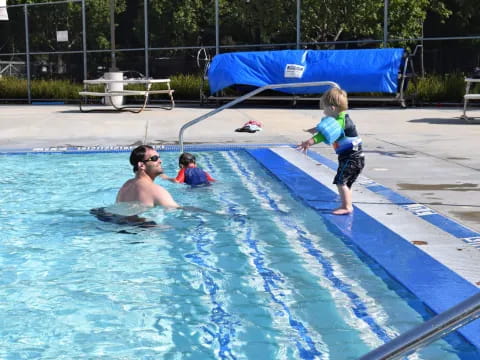 a person and a child in a pool