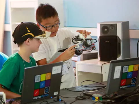 a couple of people working on a computer