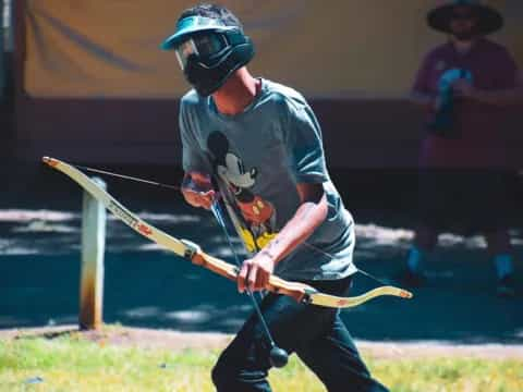 a man wearing a helmet and holding a stick