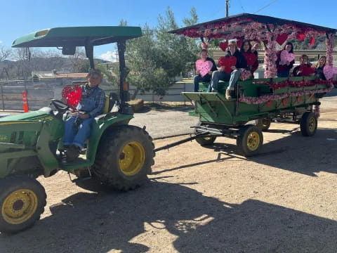 a tractor pulling a trailer with people in it