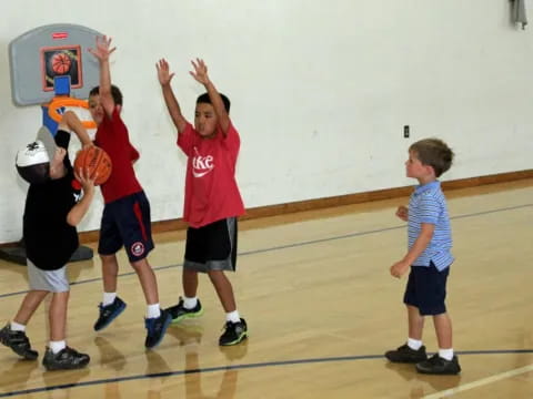 a group of boys playing basketball