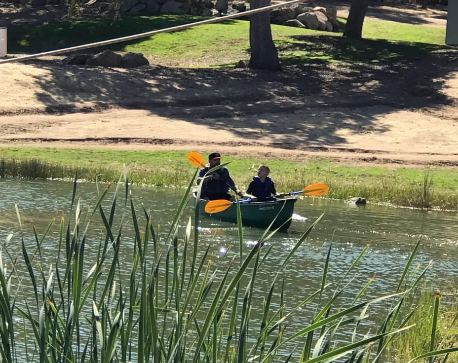 two people in a canoe on a river