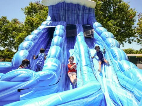 children on a large blue slide