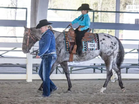 a man and a woman riding a horse