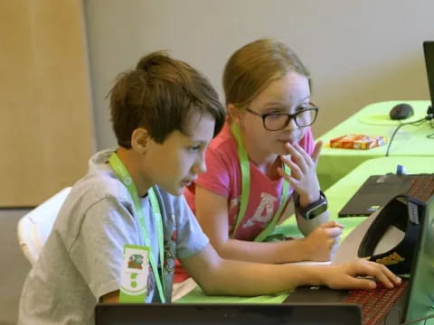 a person and a boy using a computer