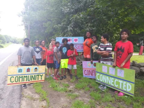 a group of people posing for a photo with signs