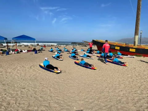 a group of people sit on the beach