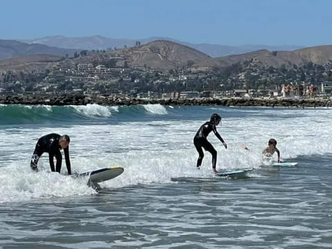 a group of surfers riding waves