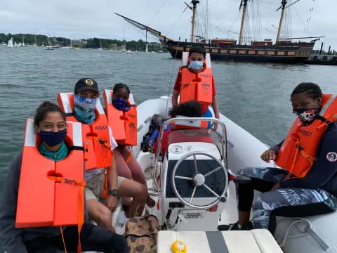 a group of people in life jackets on a boat