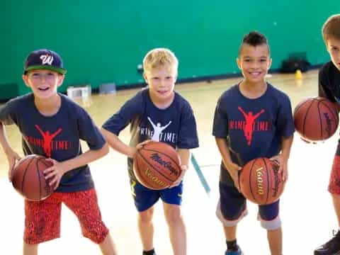 a group of boys holding basketballs
