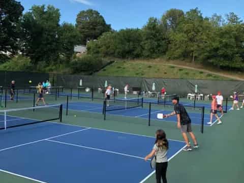 people playing tennis on a court