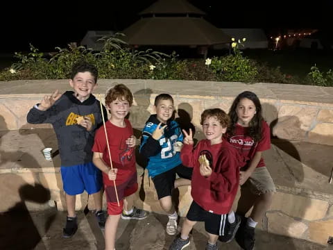 a group of kids posing for a picture